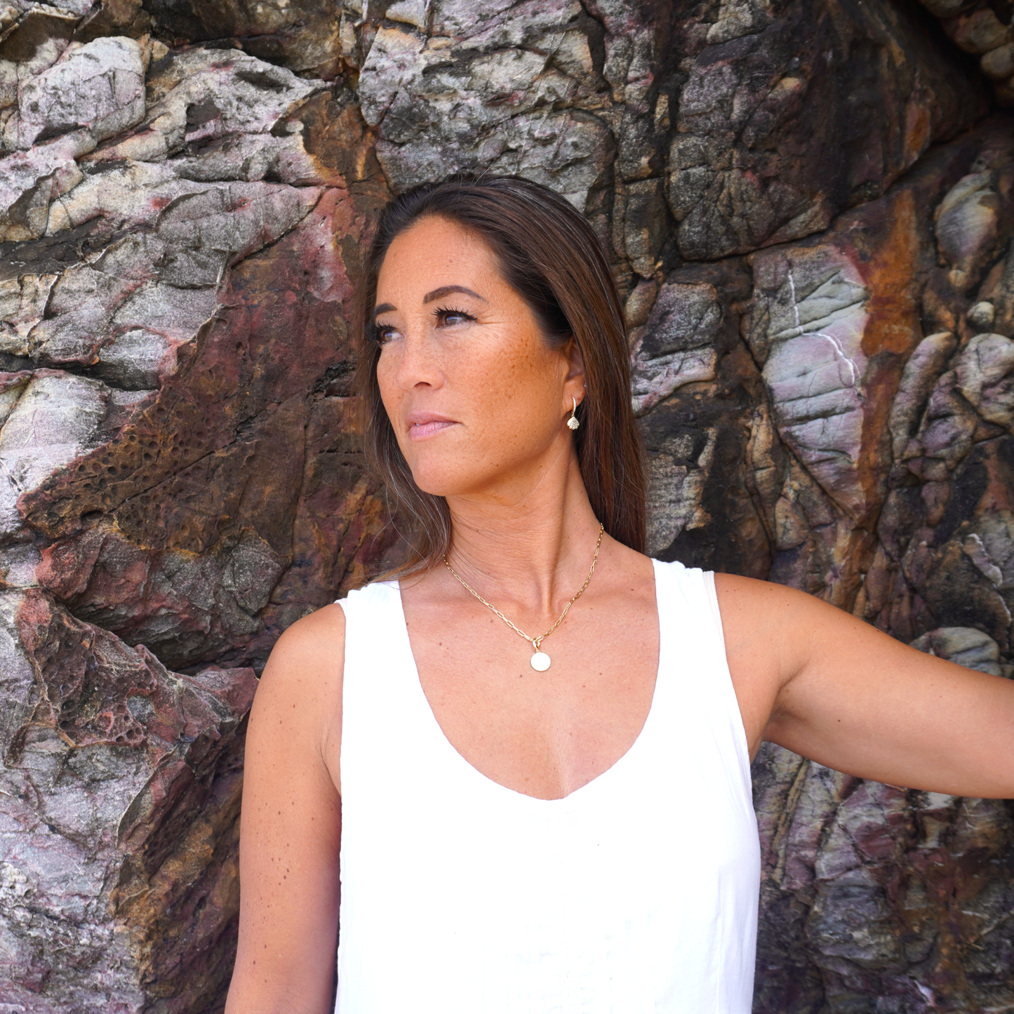 Woman wearing Aurora waterproof necklace at the ocean