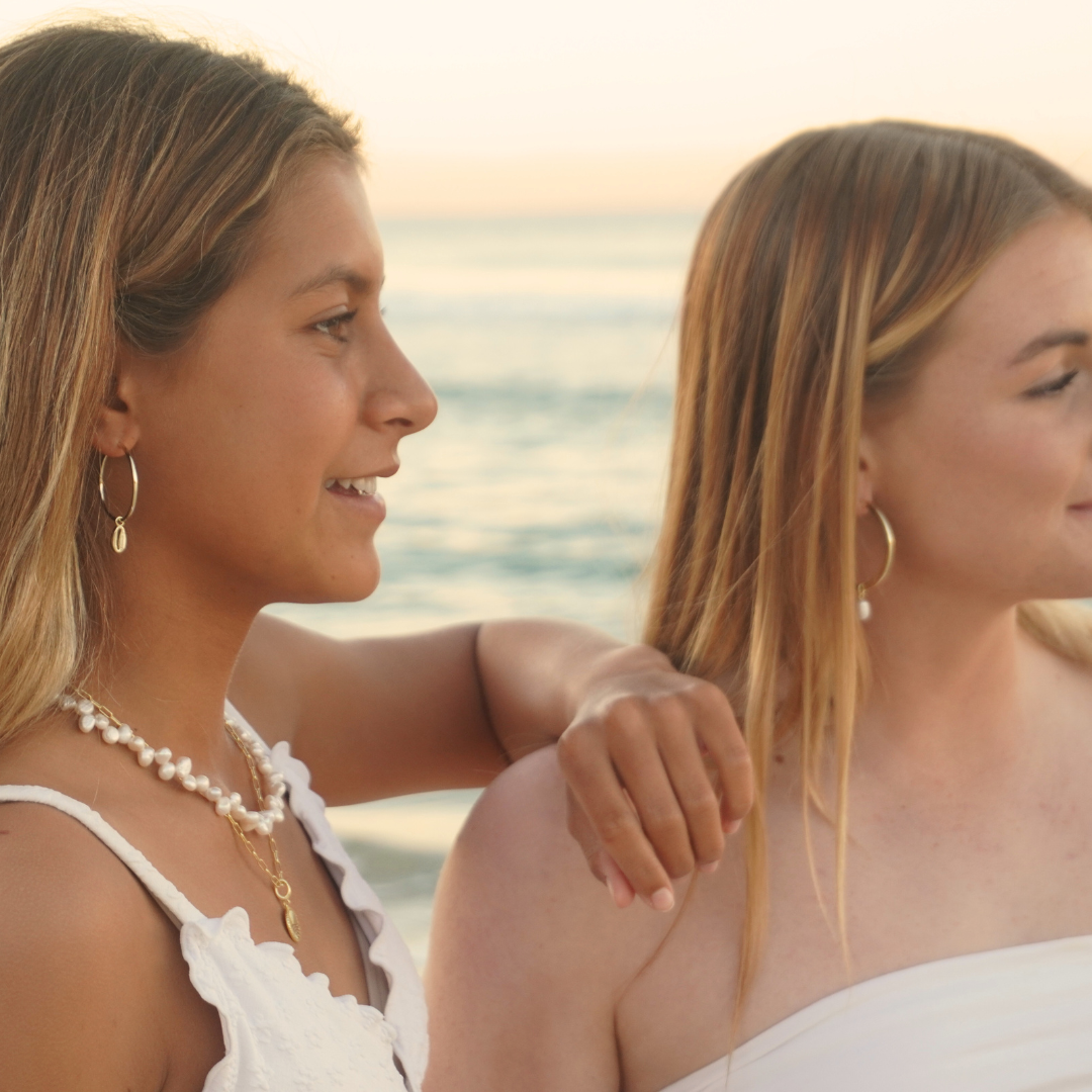 Surf Girls wearing Large Gold Cali Hoops with cowrie pendant and Luna Tide necklace and Waikiki Hoops at the beach waterproof Kailumea