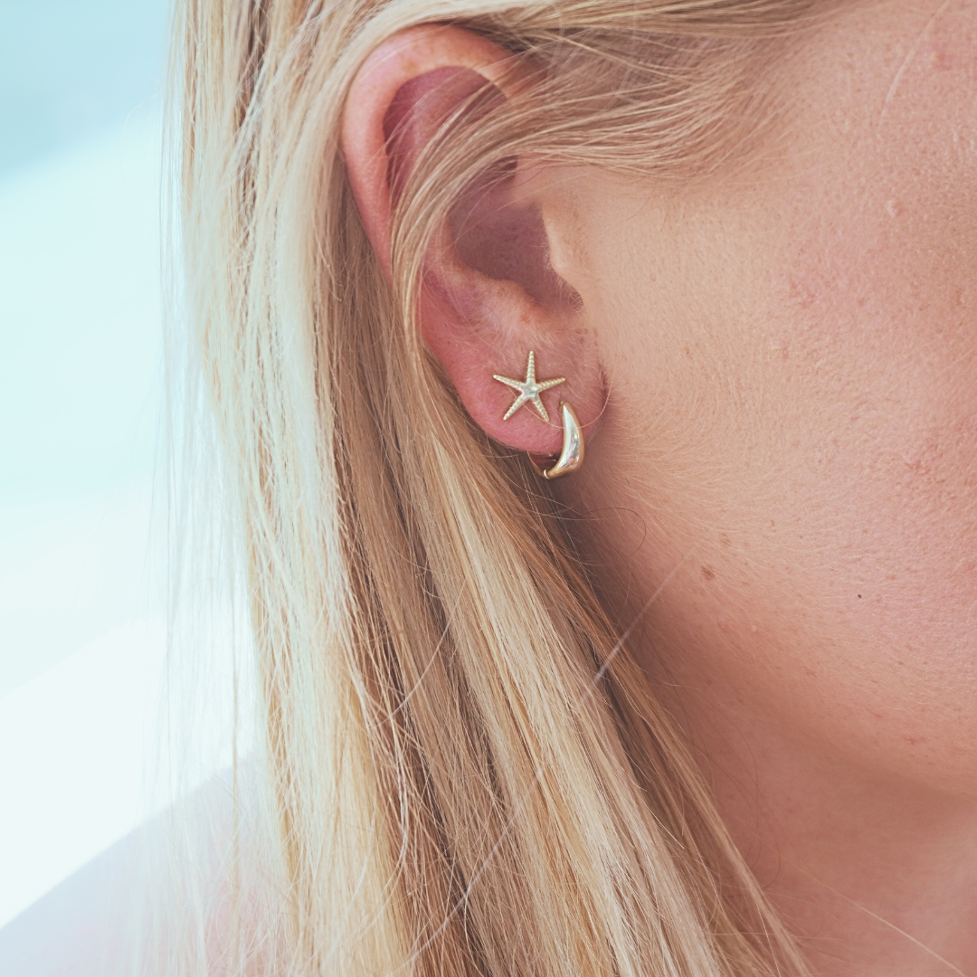 Close up in ear woman wearing Waterproof Gold Chunky Small Round Hoops and Sea star Stud earrings Kailumea