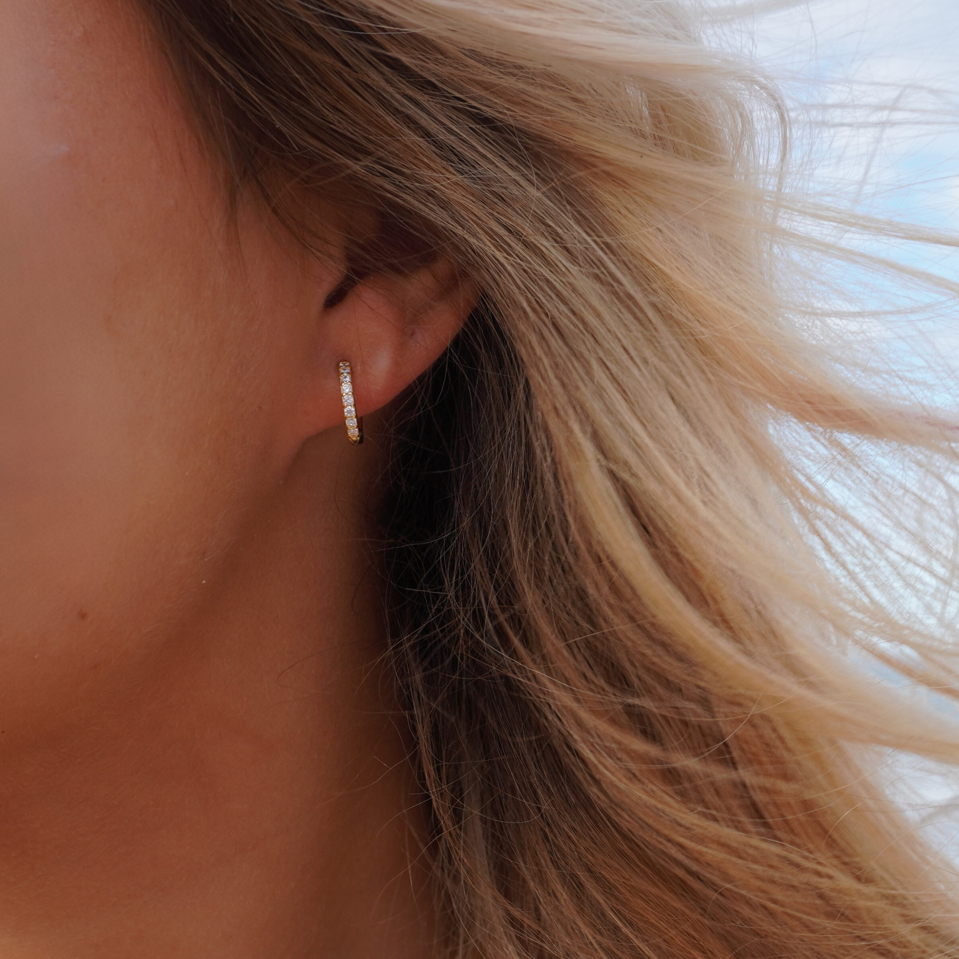 Close up in ear woman wearing Kalinda Huggie CZ Hoop Earrings waterproof Kailumea