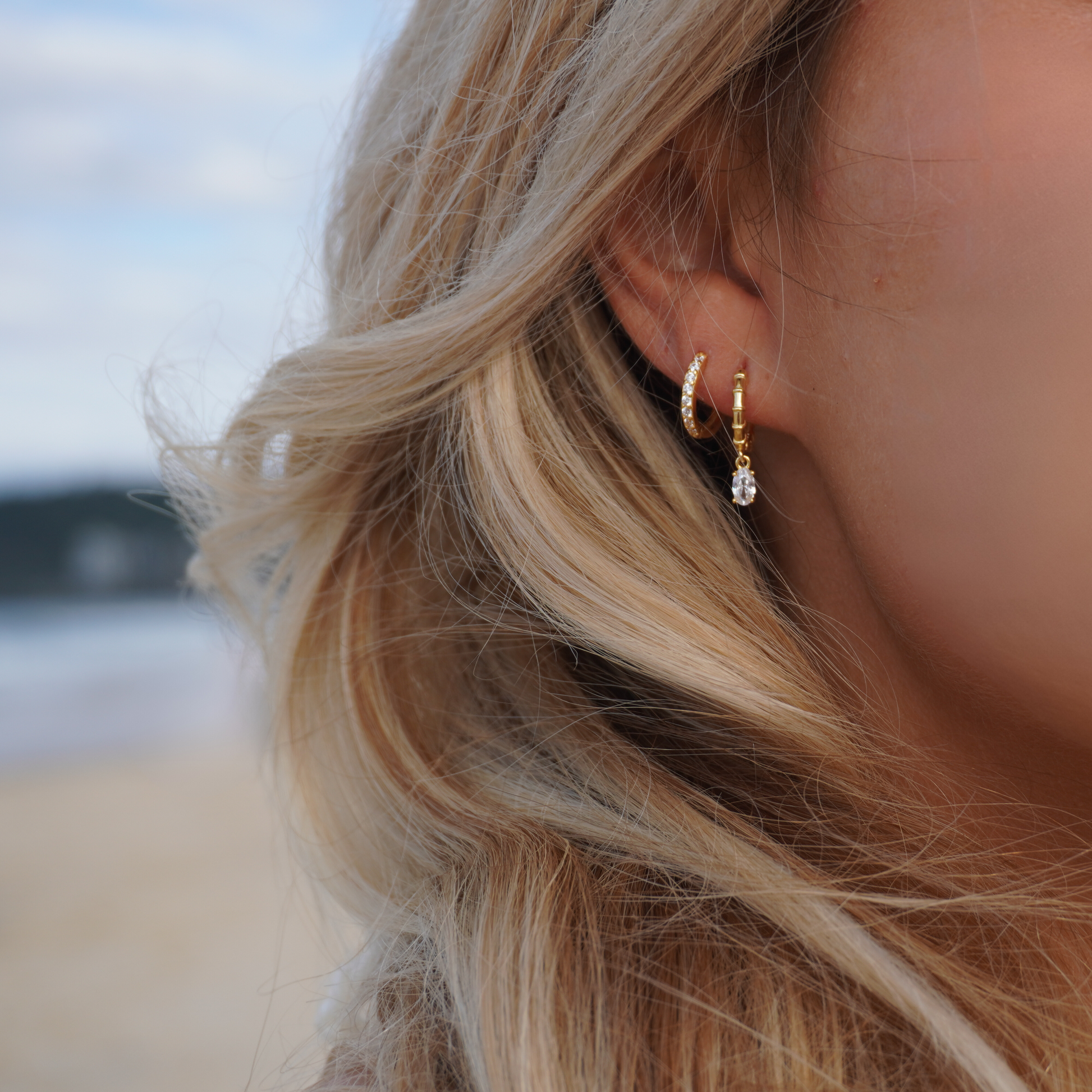 Close up in ear woman wearing Kalinda Huggie CZ Hoop Earrings waterproof Kailumea
