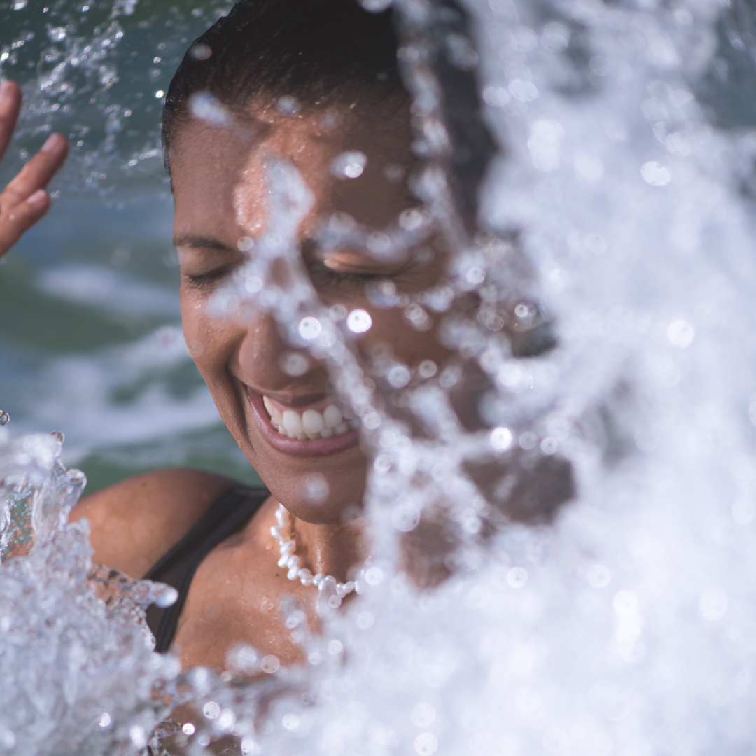 Woman modelling Luna Tide freshwater-pearl-necklace in ocean for photos only