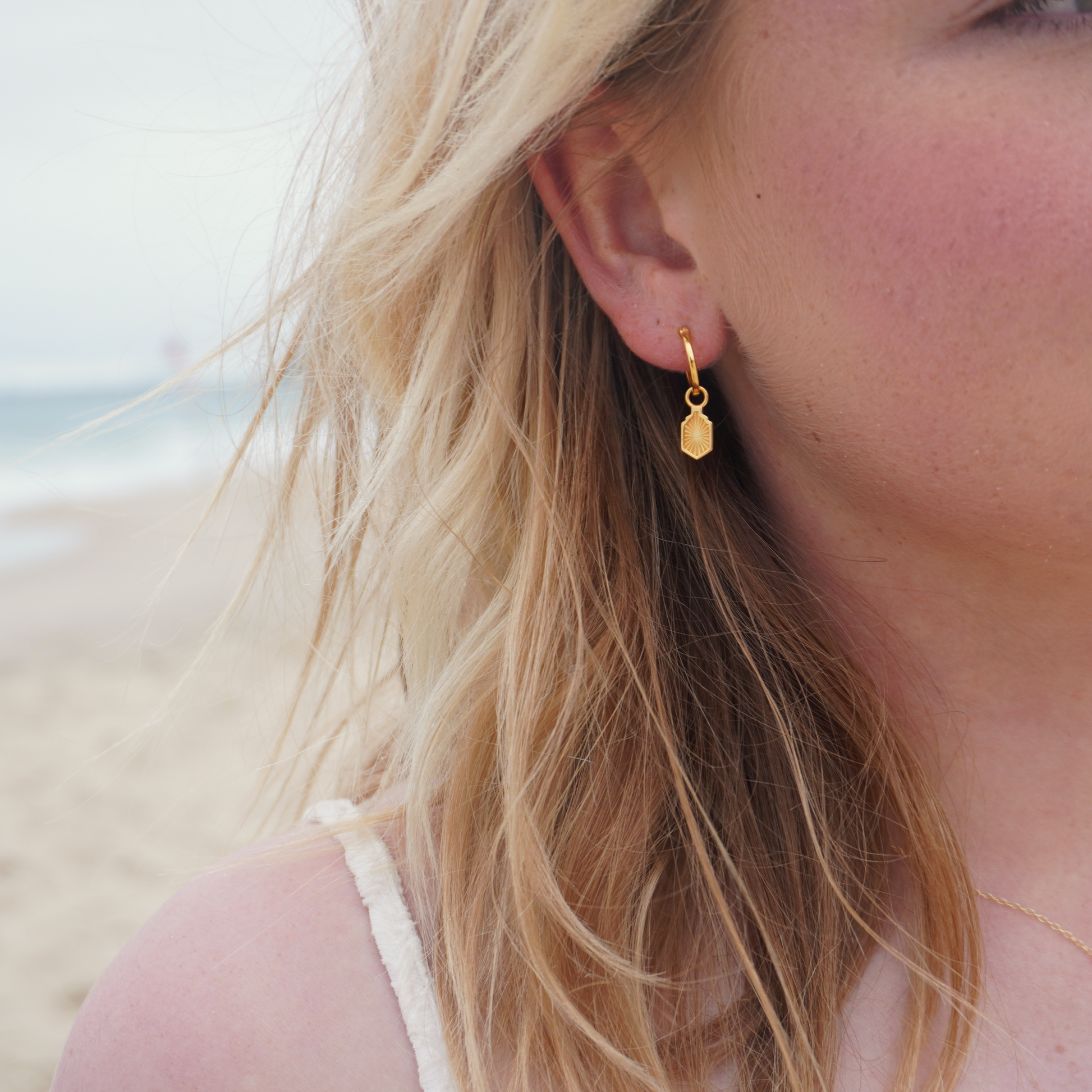 Close up in ear woman wearing Waterproof Manea Gold Boho Pendant Hoop Earrings at beach Kailumea