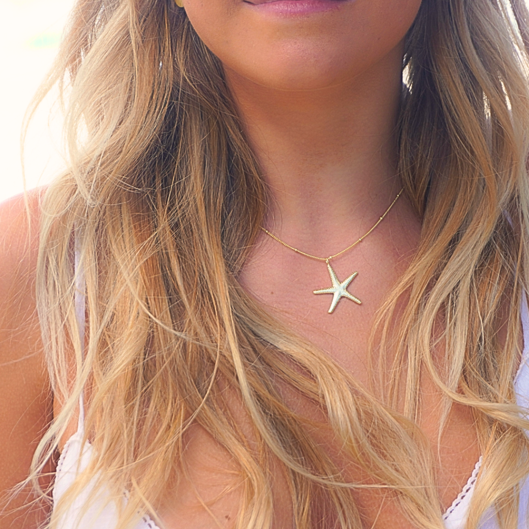 Woman wearing santorini starfish necklace at beach-Kailumea. ocean ready