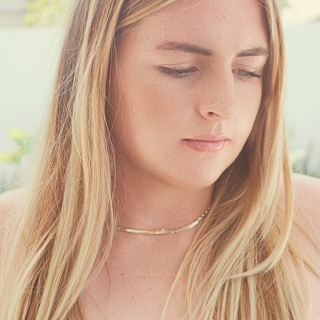 Woman wearing Zephyr Herringbone chain stacked with Mimi sparkle chain . waterproof gold Kailumea