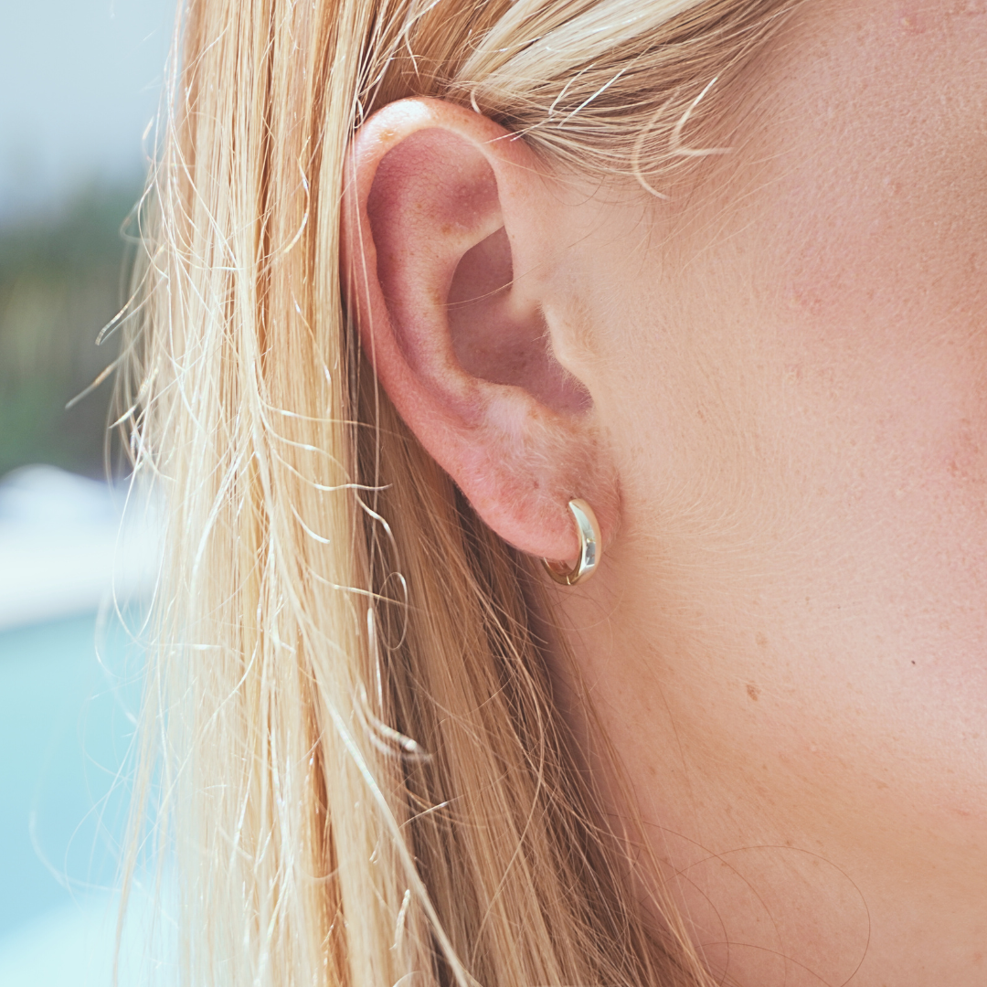 Close up in ear woman wearing Waterproof Gold Classic Small Round Hoop earrings kailumea