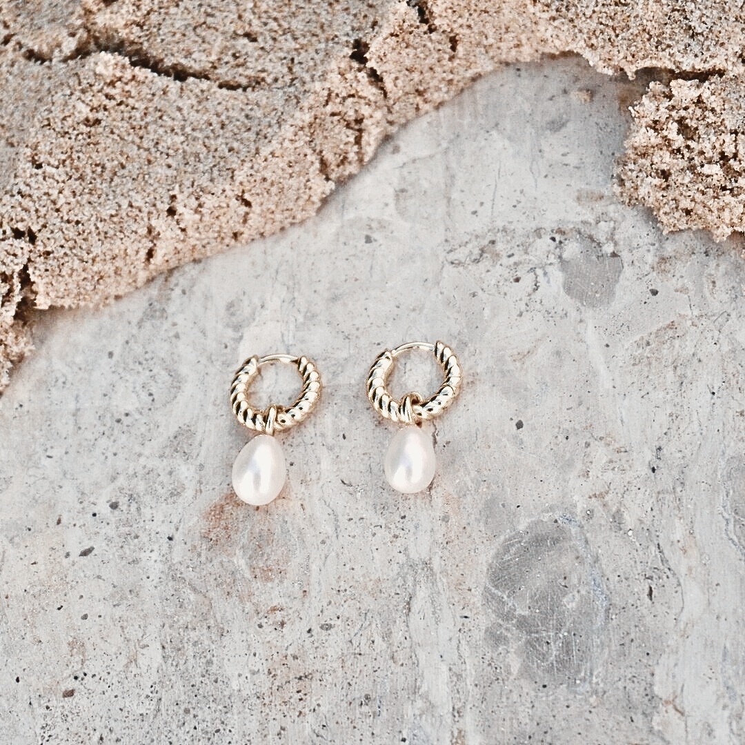 Delmar Gold Pearl Huggie Hoops flat lay waterproof Kailumea