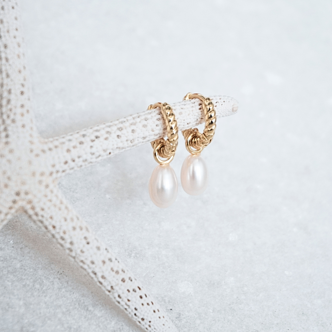 Delmar Gold Pearl Huggie Hoops flat lay waterproof Kailumea