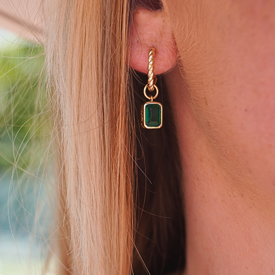 emerald gold hoops close up on ear. waterproof Kailumea
