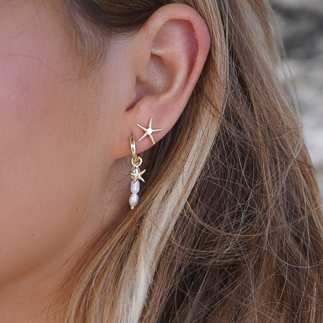 Close up in ear woman wearing Selene Starfish Pearl String hoop earrings and starfish studs waterproof Kailumea